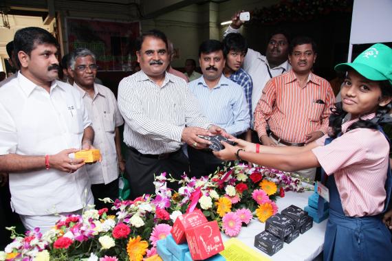 A School Student handing over Eco-Friendly Natural colour Box to Shri Radheshyam Mopalwaar, Member Secretary, M.P.C.Board, Mumbai